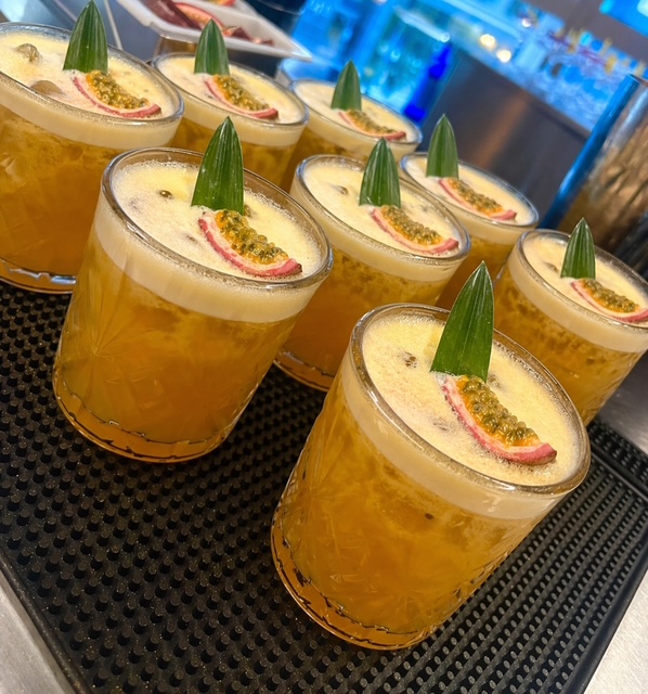 Barrowlands Stars cocktails with passionfruit and pineapple leaf garnish